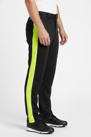 Side view of Maania Wears black baseball pants featuring a wide neon yellow vertical stripe and black turf shoes.