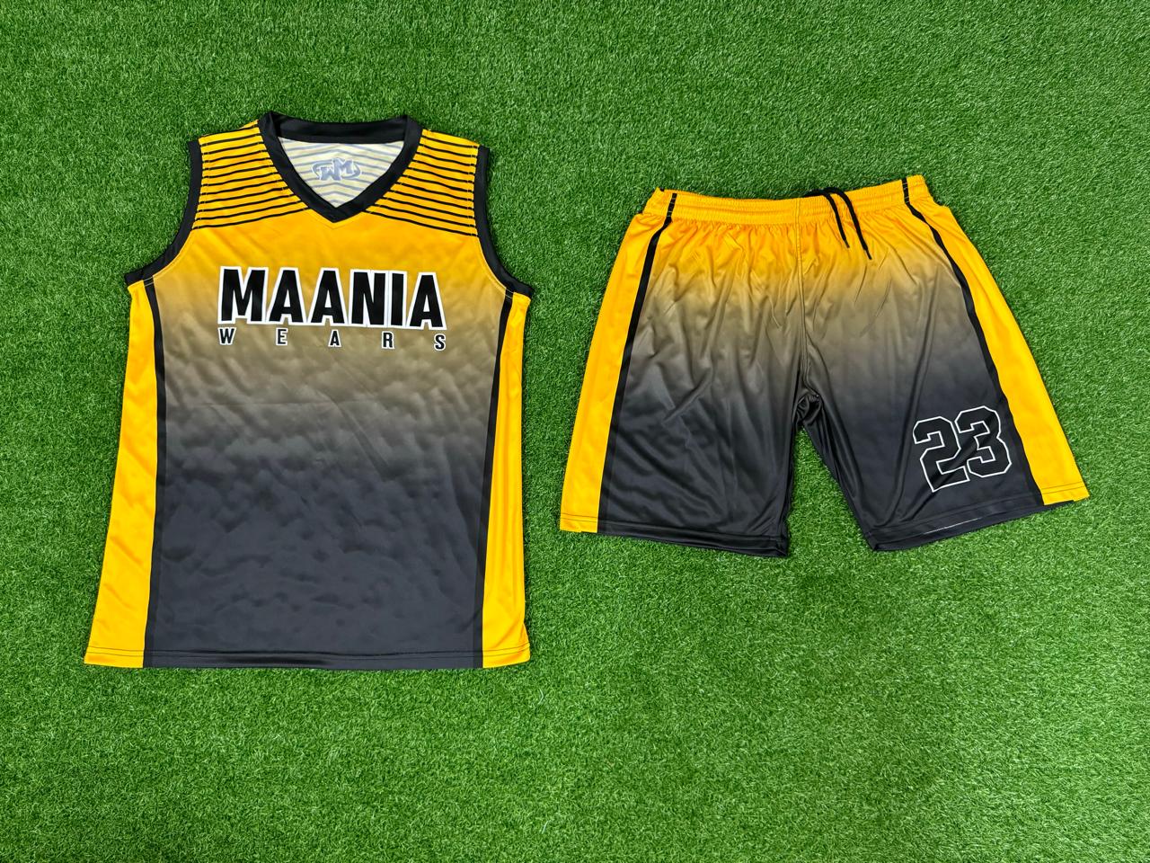 Model wearing Maania Wears yellow and black sleeveless training uniform with gradient fade and number 23 on shorts.